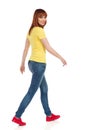 Young Casual Woman Is Walking And Looking At Camera Over The Shoulder Royalty Free Stock Photo