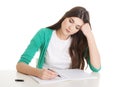 Young casual woman writing in workbook.