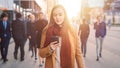 Young Casually Dressed Female is Using a Smartphone on a Street. Business People and Office Manage Royalty Free Stock Photo