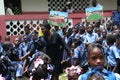 Young Catholic Haitian schoolchildren in front of rural school with teachers.