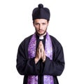 Young catholic priest praying