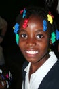 Young Catholic school girl is all smiles in rural village clinic.