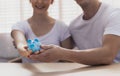 Money saving. Young Caucacian couple holding piggy bank together