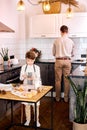 young caucasian american family, kid making baking cookies in modern kitchen Royalty Free Stock Photo