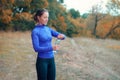 A young caucasian athletic woman opens a bottle with water after