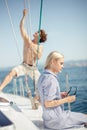 Young caucasian attractive couple navigating a yacht in caribbean sea Royalty Free Stock Photo