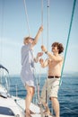 Young caucasian attractive couple navigating a yacht in caribbean sea Royalty Free Stock Photo