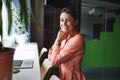 Young Caucasian attractive woman entrepreneur holding her hands under the chin while leaning on the chair Royalty Free Stock Photo