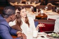 Group of young people meeting in restaurant at dinner