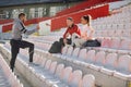 Young caucasian beardy guy standing and talking to smiling couple. personal trainer concept