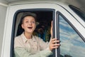 Young caucasian beautiful girl with a shaved head and her African female friend on the back seat looking out of the open Royalty Free Stock Photo