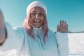 Young Caucasian Beautiful pink hair woman smile at camera taking selfie photo or video call in winter snow forest Royalty Free Stock Photo