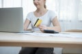 Young  caucasian beautiful woman using laptop computer and holding credit card. Online shopping, e-commerce, spending money, Royalty Free Stock Photo