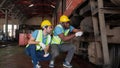 Young caucasian and black engineer maintenance and repair train diesel engine in station.