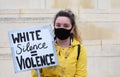 A young caucasian BLM protester with a sign that reads `White Silence quals White Violence`