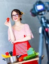 Young caucasian blogger woman cooking Vegan food