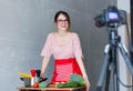 Young caucasian blogger woman cooking Vegan food