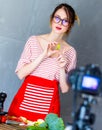 Young caucasian blogger woman cooking Vegan food