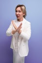 young caucasian blond lady in a white jacket and dress crossed her arms Royalty Free Stock Photo