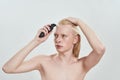 Young caucasian blond man using hair trimmer Royalty Free Stock Photo