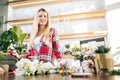 Gardening. Young caucasian florist woman working at garden Royalty Free Stock Photo