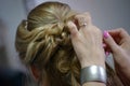 Young Caucasian blonde woman having her hair done for the wedding or a formal event Royalty Free Stock Photo