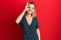 Young caucasian blonde woman wearing beautiful black and white dress doing ok gesture with hand smiling, eye looking through Royalty Free Stock Photo