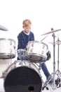 Young caucasian boy at drum kit in studio plays music Royalty Free Stock Photo