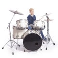 Young caucasian boy at drum kit in studio plays music Royalty Free Stock Photo