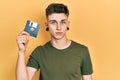 Young caucasian boy with ears dilation holding floppy disk thinking attitude and sober expression looking self confident Royalty Free Stock Photo