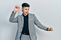 Young caucasian boy with ears dilation wearing business jacket dancing happy and cheerful, smiling moving casual and confident Royalty Free Stock Photo