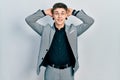 Young caucasian boy with ears dilation wearing business jacket relaxing and stretching, arms and hands behind head and neck Royalty Free Stock Photo