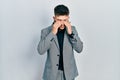 Young caucasian boy with ears dilation wearing business jacket rubbing eyes for fatigue and headache, sleepy and tired expression Royalty Free Stock Photo