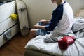 Young caucasian boy holding game control sitting on bed