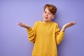 young boy is misunderstanding what happened, shrugging, spreading arms at side Royalty Free Stock Photo