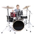 young caucasian boy plays drums in studio against white background Royalty Free Stock Photo