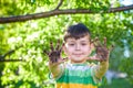 A young Caucasian boy showing off his dirty hands after playing in dirt and sand Royalty Free Stock Photo