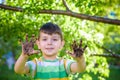 A young Caucasian boy showing off his dirty hands after playing in dirt and sand Royalty Free Stock Photo