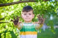 A young Caucasian boy showing off his dirty hands after playing in dirt and sand Royalty Free Stock Photo