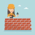 Young caucasian bricklayer building a brick wall.