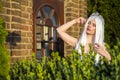 Young Caucasian Bride with Long White Hair Posing Against Old Brick Building Outdoors Royalty Free Stock Photo