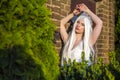 Young Caucasian Bride with Tiara and Long White Hair Posing Against Old Brick Wall  Outdoors Royalty Free Stock Photo