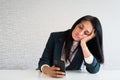 Young caucasian brunette business woman director in office sit at desk use phone scroll news social media bored at work director Royalty Free Stock Photo