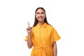 young caucasian brunette woman with long hair dressed in a yellow summer dress is trying to remember something important Royalty Free Stock Photo