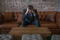 Young caucasian business man in formal suit sitting on sofa clutching his head Royalty Free Stock Photo