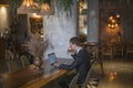 Young caucasian business man in formal suit working on laptop in a bar Royalty Free Stock Photo