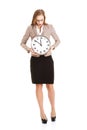 Young caucasian business woman holding clock. Royalty Free Stock Photo