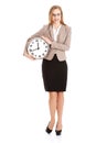 Young caucasian business woman holding clock. Royalty Free Stock Photo