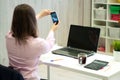 Young caucasian business woman in pink shirt in office doing selfie on the phone Royalty Free Stock Photo