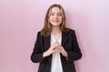 Young caucasian business woman wearing black jacket hands together and fingers crossed smiling relaxed and cheerful Royalty Free Stock Photo